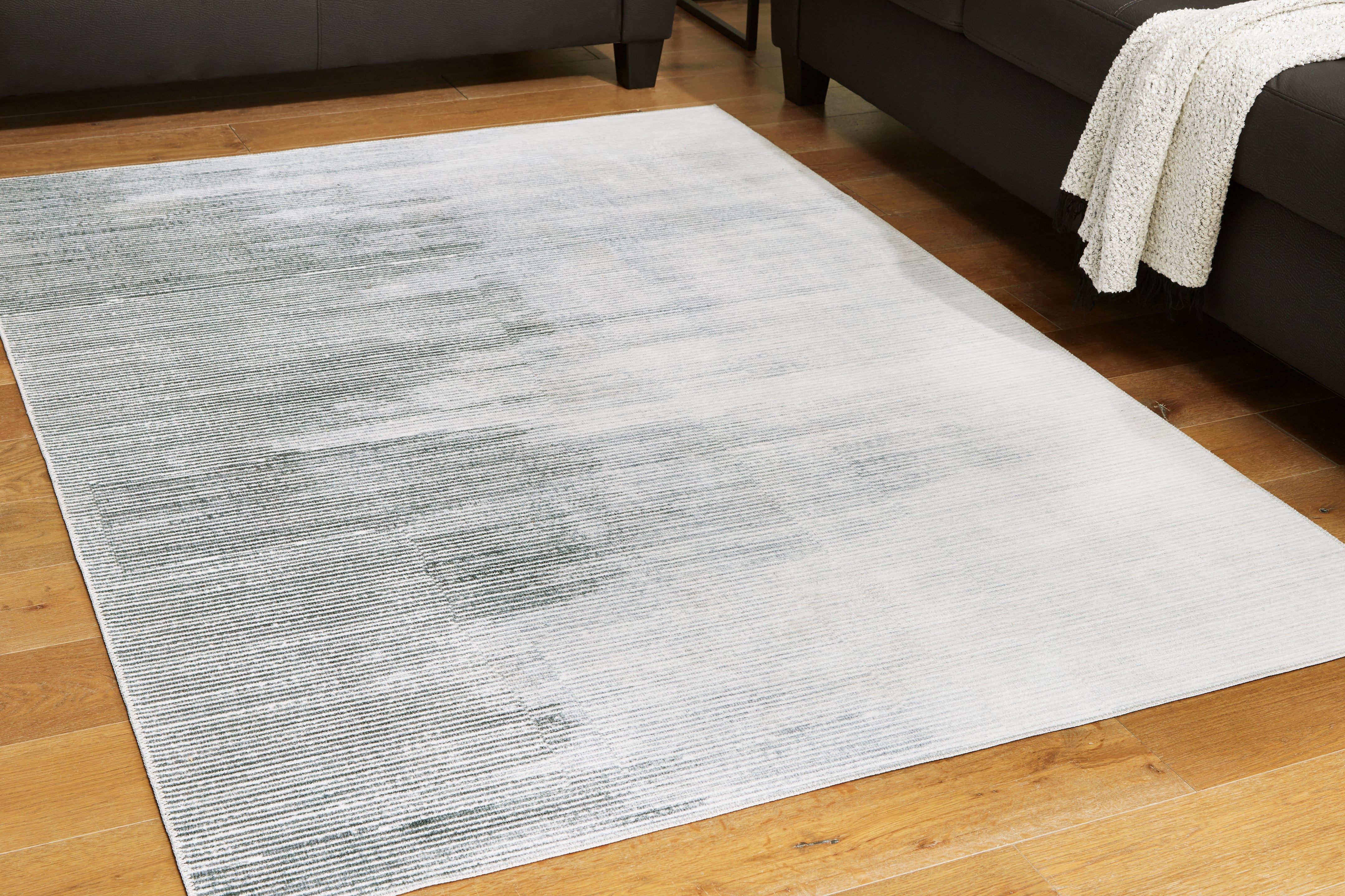 Bay Furniture Gallery - Ashley Furniture - Milset Rug - 5'1" x 6'10" Washable Rug / Black/White/Gray - R406252