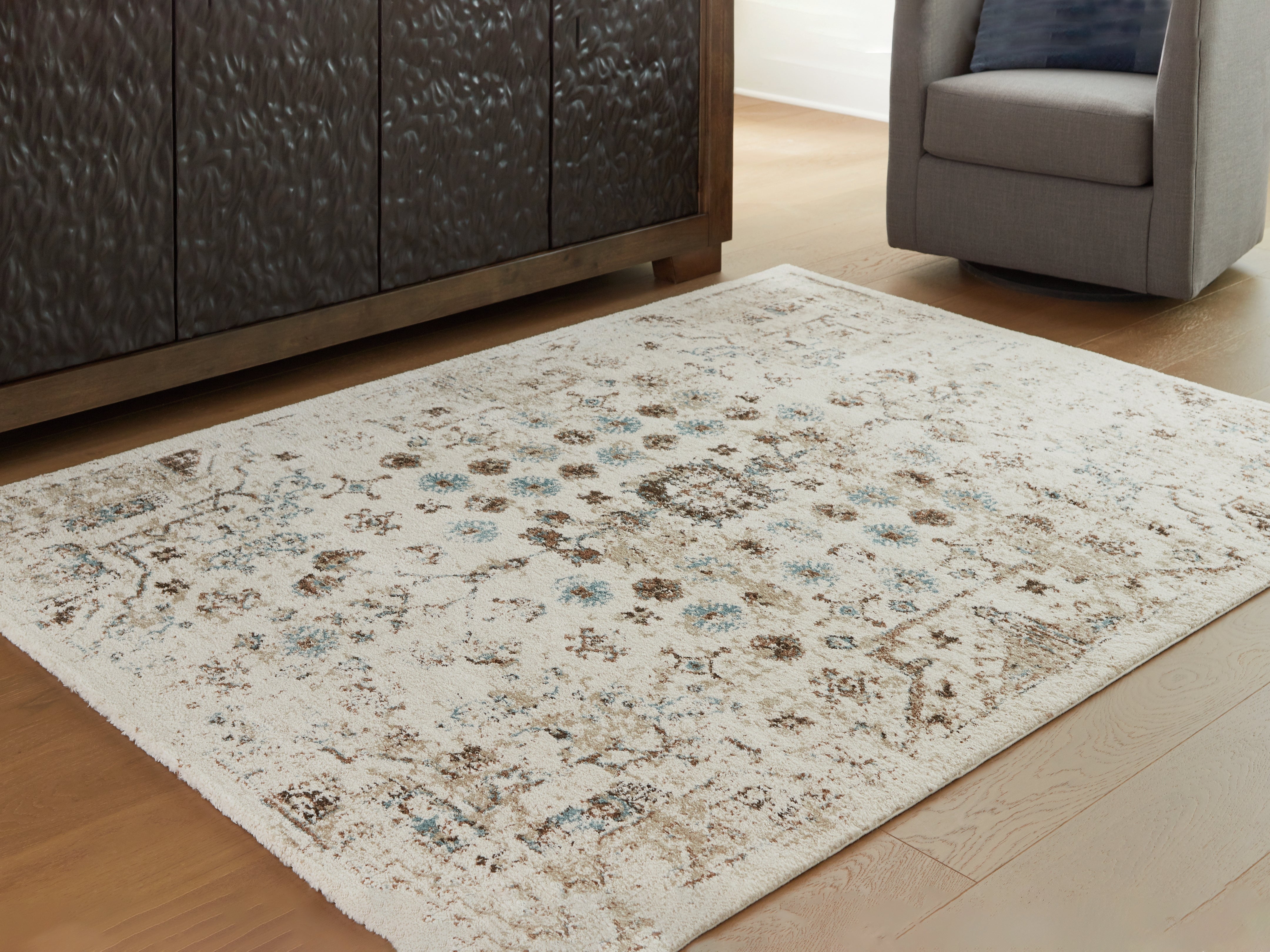Bay Furniture Gallery - Ashley Furniture - Jossler Rug - 5' x 7' Rug / Ivory/Brown/Teal - R407072