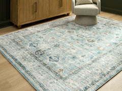 Bay Furniture Gallery - Ashley Furniture - Ladstoney Rug - 7'6" x 9'6" Area Rug / Teal/Beige/Ochre - R407501