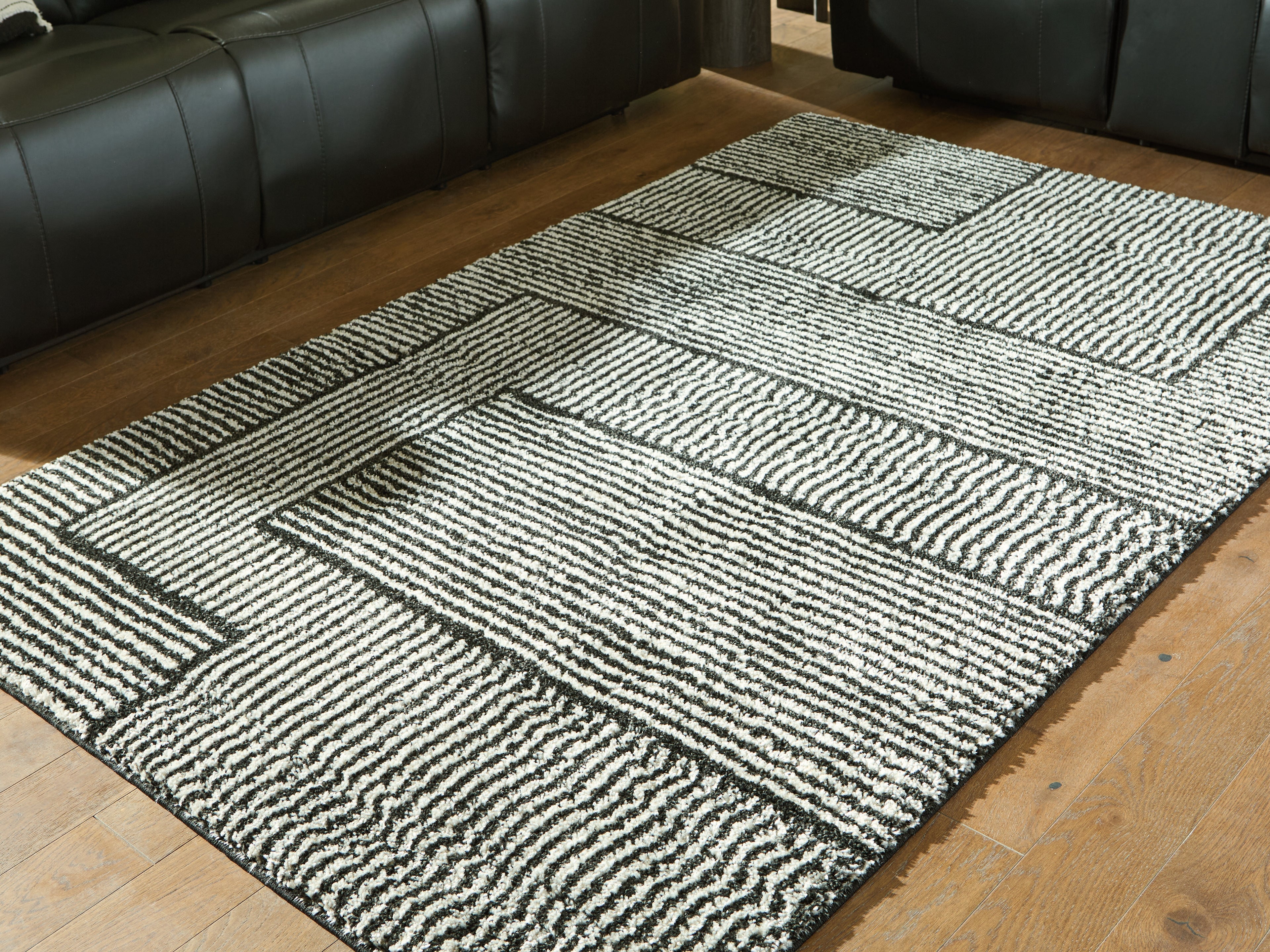 Bay Furniture Gallery - Ashley Furniture - Kurtmen Rug - 5' x 7' Area Rug / Black/Ivory - R407592