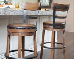 Bay Furniture Gallery - Ashley Furniture - Pinnadel Dining Room - UPH Swivel Barstool (1/CN) / Light Brown - D542-124