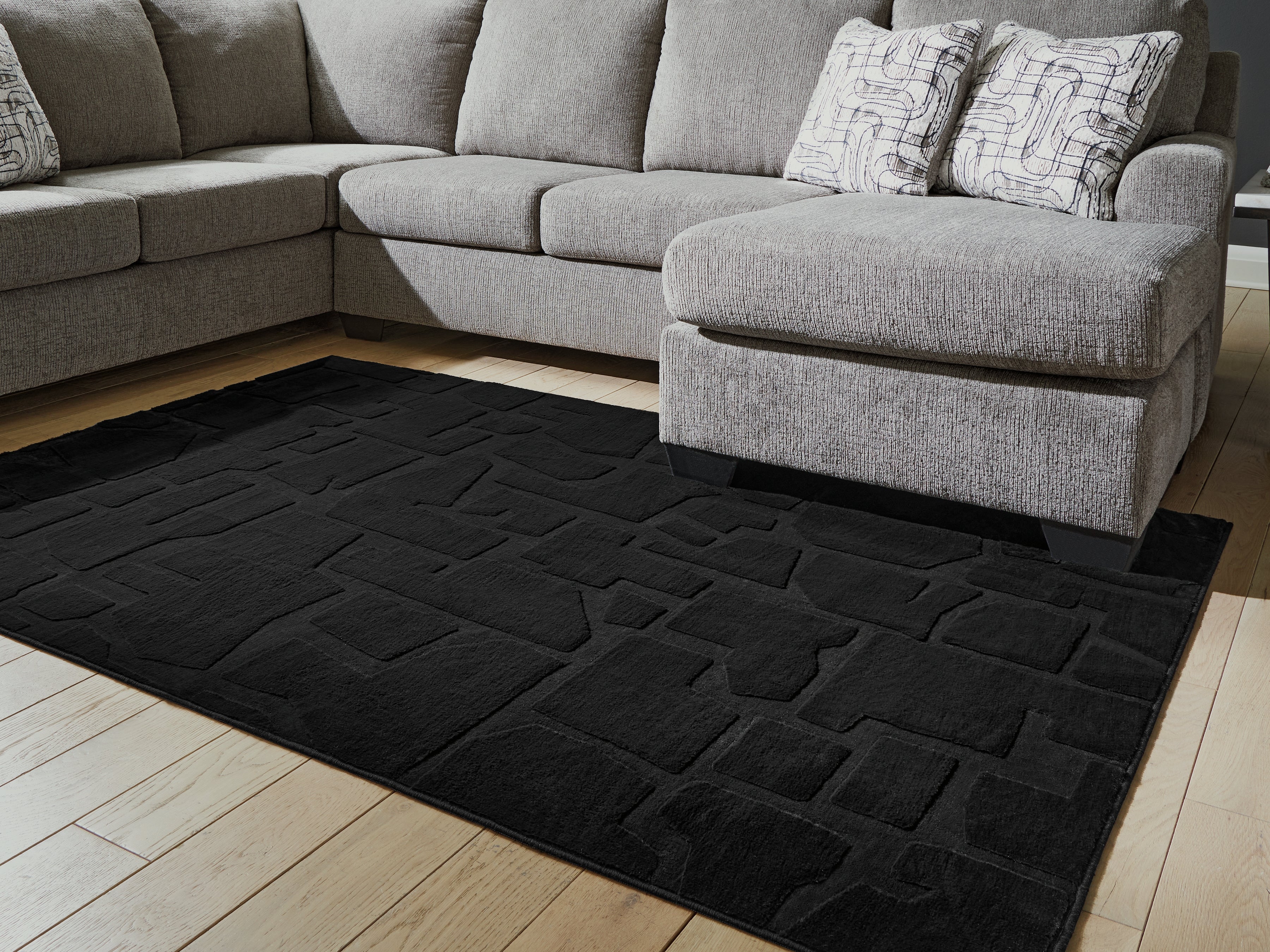 Bay Furniture Gallery - Ashley Furniture - Gibbswell Rug - Washable 5' x 7' Area Rug / Black - R407462