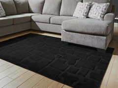 Bay Furniture Gallery - Ashley Furniture - Gibbswell Rug - Washable 5' x 7' Area Rug / Black - R407462