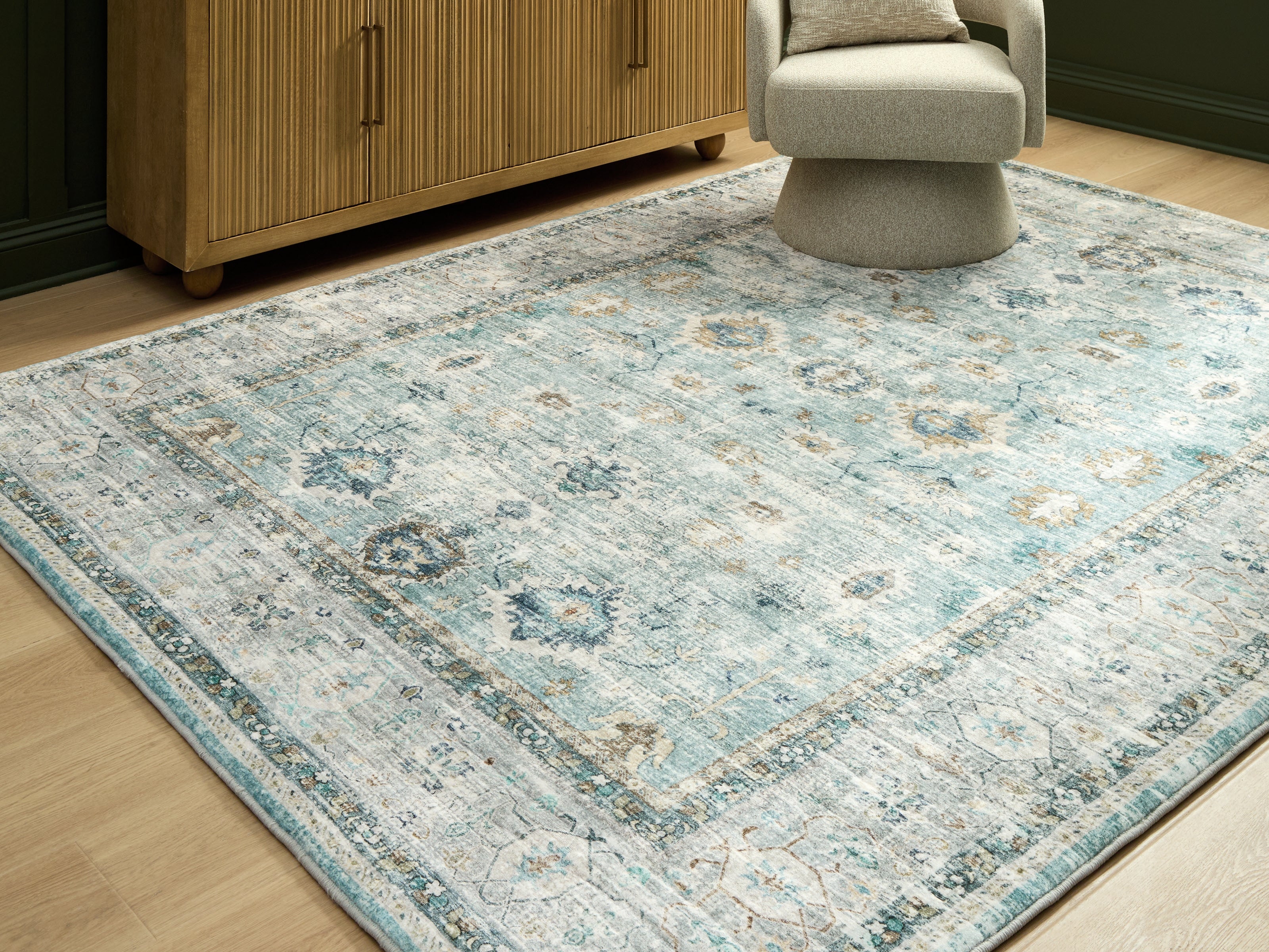 Bay Furniture Gallery - Ashley Furniture - Ladstoney Rug - 7'6" x 9'6" Area Rug / Teal/Beige/Ochre - R407501