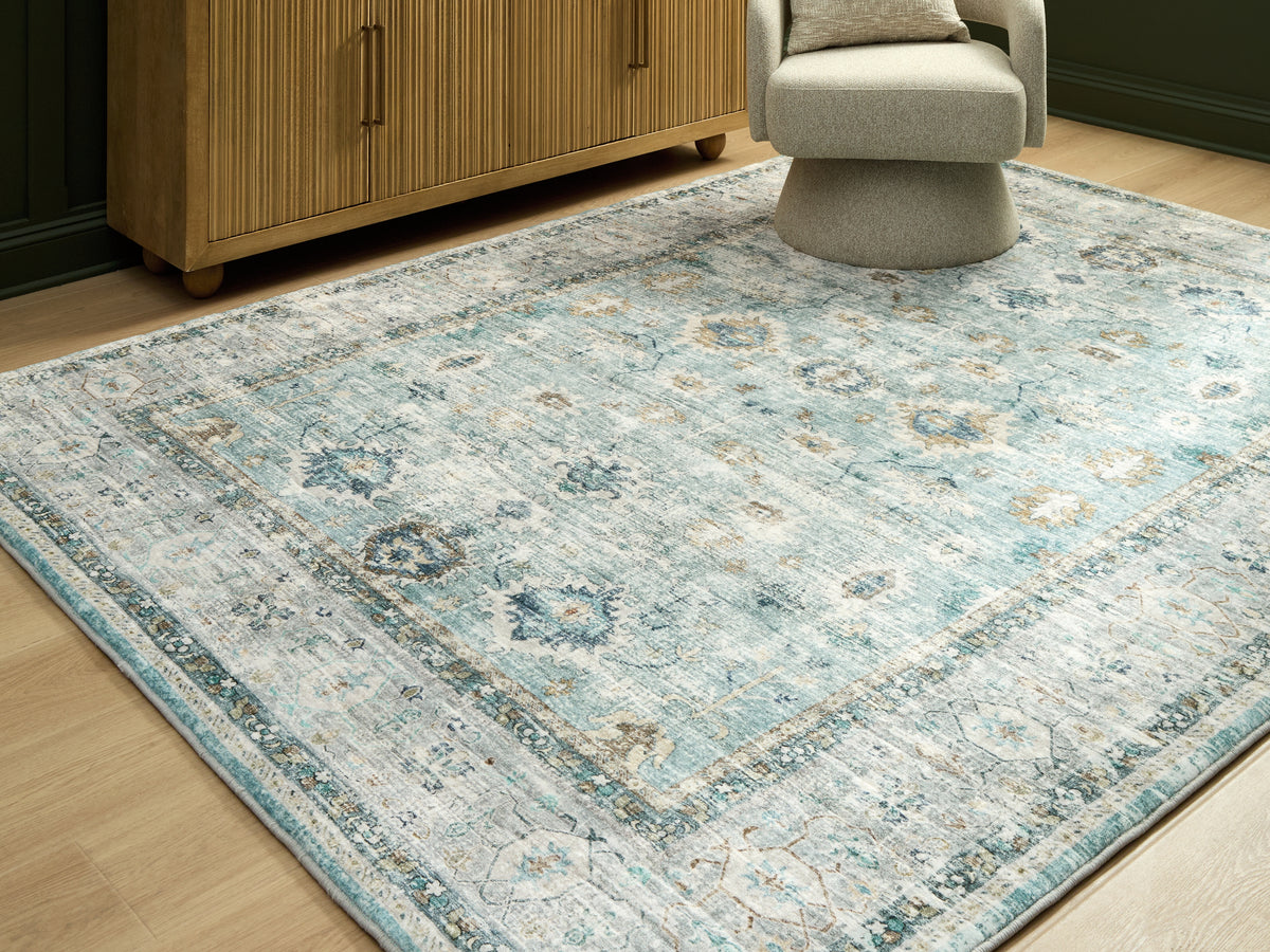 Bay Furniture Gallery - Ashley Furniture - Ladstoney Rug - 7'6" x 9'6" Area Rug / Teal/Beige/Ochre - R407501