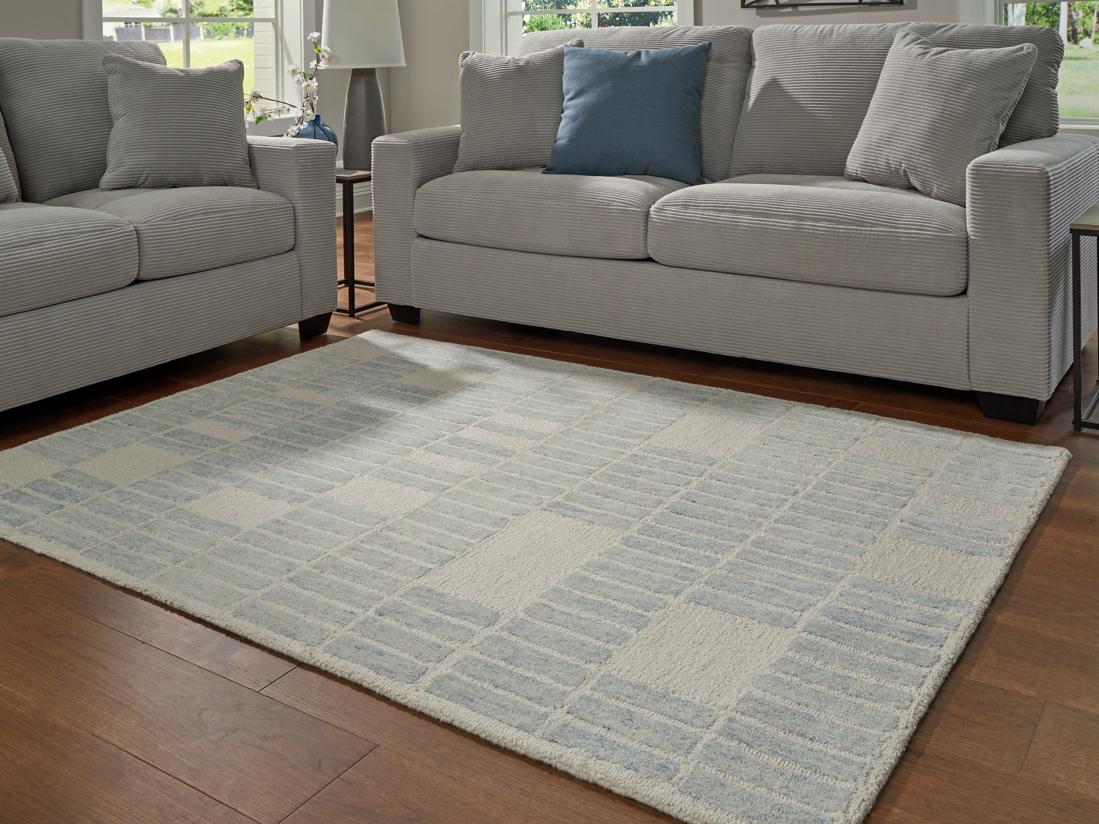 Bay Furniture Gallery - Ashley Furniture - Dylanton Rug - 5' x 7' Area Rug / Ivory/Blue - R407812